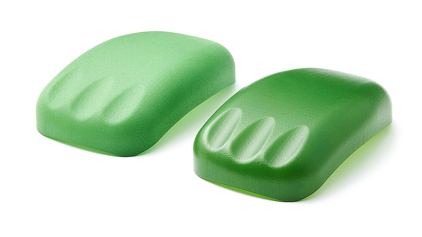 One matte green and one bright green plastic mouse with 3 fingerprints